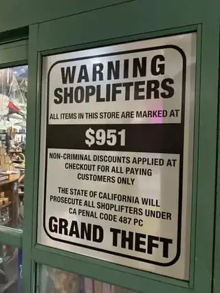 the sign in question, consisting of a text warning shopéifters about the high price