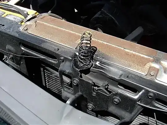 http://www.feartheelcamino.com/Images/ReBirth/More%20Mods%20To%20Relocated%20Hood%20Spring%20On%20Radiator%20Support.JPG