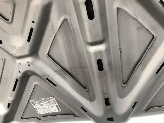 Pink fluid on underside of hood