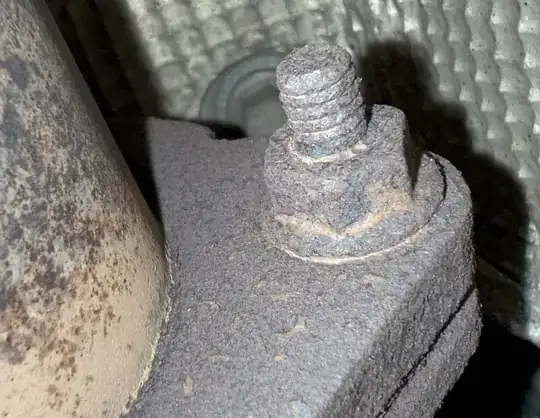close up of the rusted muffler flange nut