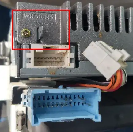 small metal tab on back of car radio