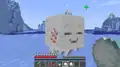 A player feeding a ghastling with snowballs in the frozen ocean biome