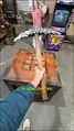 Mumbo Jumbo holding a pickaxe.