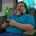 Jack Black out of character, playing Minecraft in his Steve costume.