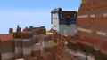 Steve next to a harnessed happy ghast in a badlands