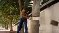 A woman chopping down a tree with an axe.