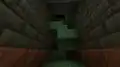 A staircase at the end of a trial chamber hallway.
