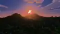 The bloom effect around the sun during sunrise.