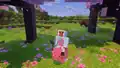 A player steering a pig with a carrot on a stick in a cherry grove