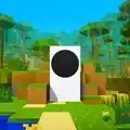 An Xbox Series S console in-game in Minecraft towering above the environment and surrounded by trees.