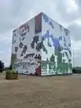 An image of the block, with artwork being put together on all sides.