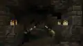 A screenshot of a corridor with lit candles inside an ancient city.