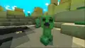 A green creature with no arms and a square head. It has black eyes and a gaping, misshapen mouth