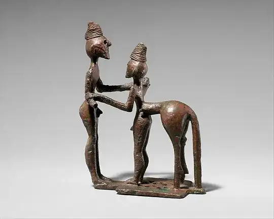 bronze centaur with human front legs next to a man