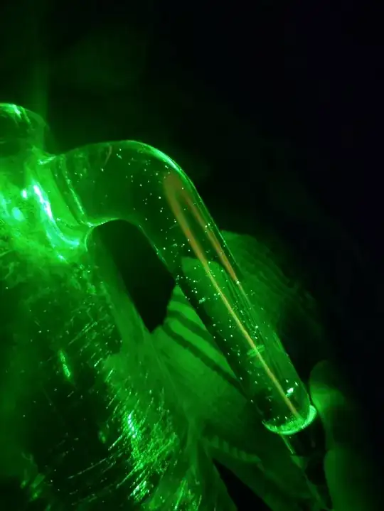 Green Laser shone into handle of glass jug; a beam of reddish light is visible following the rest emanating from the coupling point