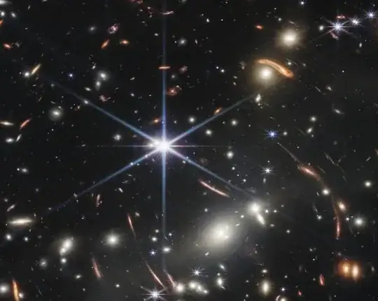 webb image showing some stars with very visible rays and others without