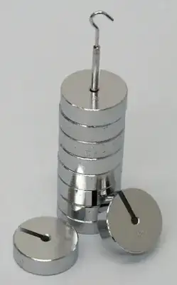 Picture of small metal disks slotted onto as hook, such as could be attached to a spring to study Hooke's law