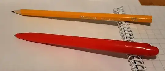 Photo of yellow pencil and red ballpoint pen on white paper