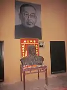 Bronze Statue of Xie Juezai at the table in the main room.