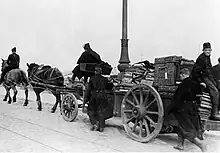 B&W of people on a packed cart