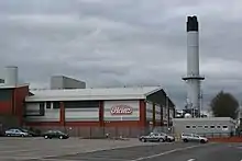 Image 11Heinz, although based in Hayes in Middlesex, has the largest food processing complex in Europe at a 55-acre (22 ha) site at Kitt Green in Wigan, which produces 1.4 billion cans of food each year; it is accessed to the east of the Orrell Interchange of the M6 (A577); the 38-acre Heinz NDC is next door (from North West England)