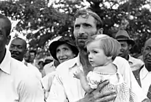 Image 37Man with child at a meeting of the Southern Tenant Farmers Union, 1937 (from History of Arkansas)