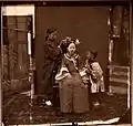 Manchu lady having her hair styled. John Thomson. China, 1869. The Wellcome Collection, London