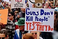 A person carrying a placard amidst a demonstration
