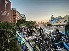 Protesters walking on the rooftop of the bridge connecting PolyU and nearby districts