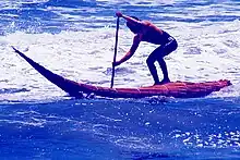 Surfing in a caballito de totora in Huanchaco
