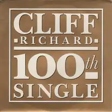 Record sleeve showing a gold background with bold white letters 'Cliff Richard 100th Single'