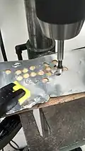 Using the drill press to punch out the washers