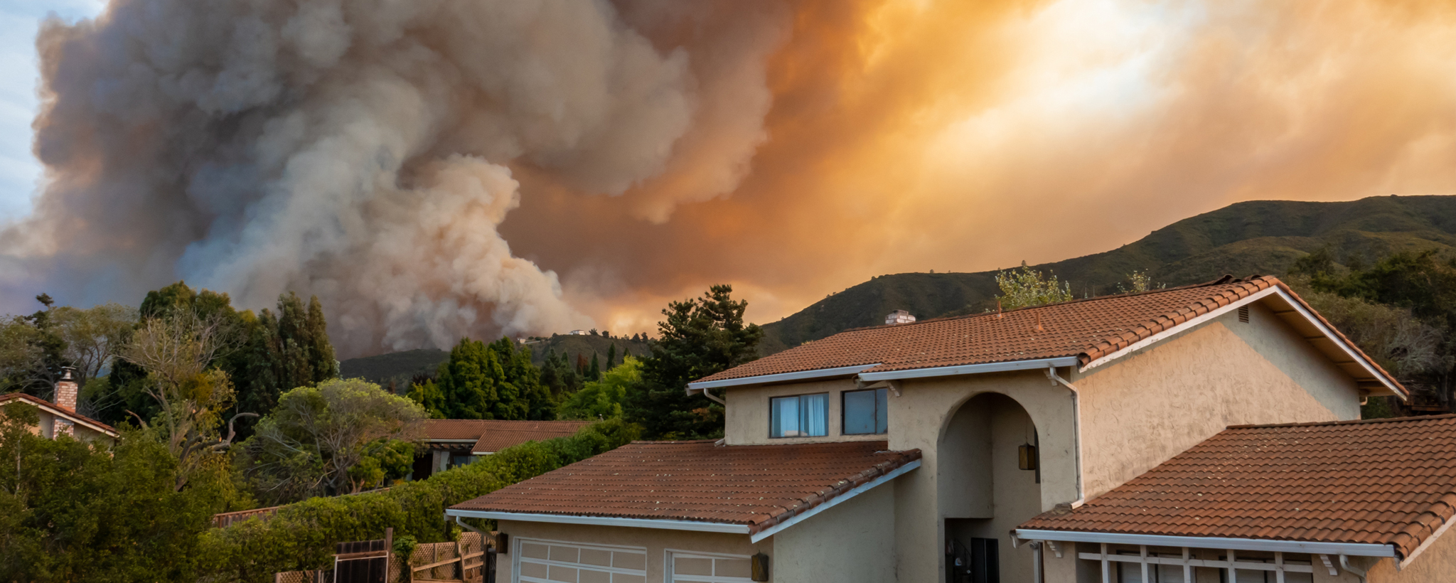 House with wildfire smoke in the background.