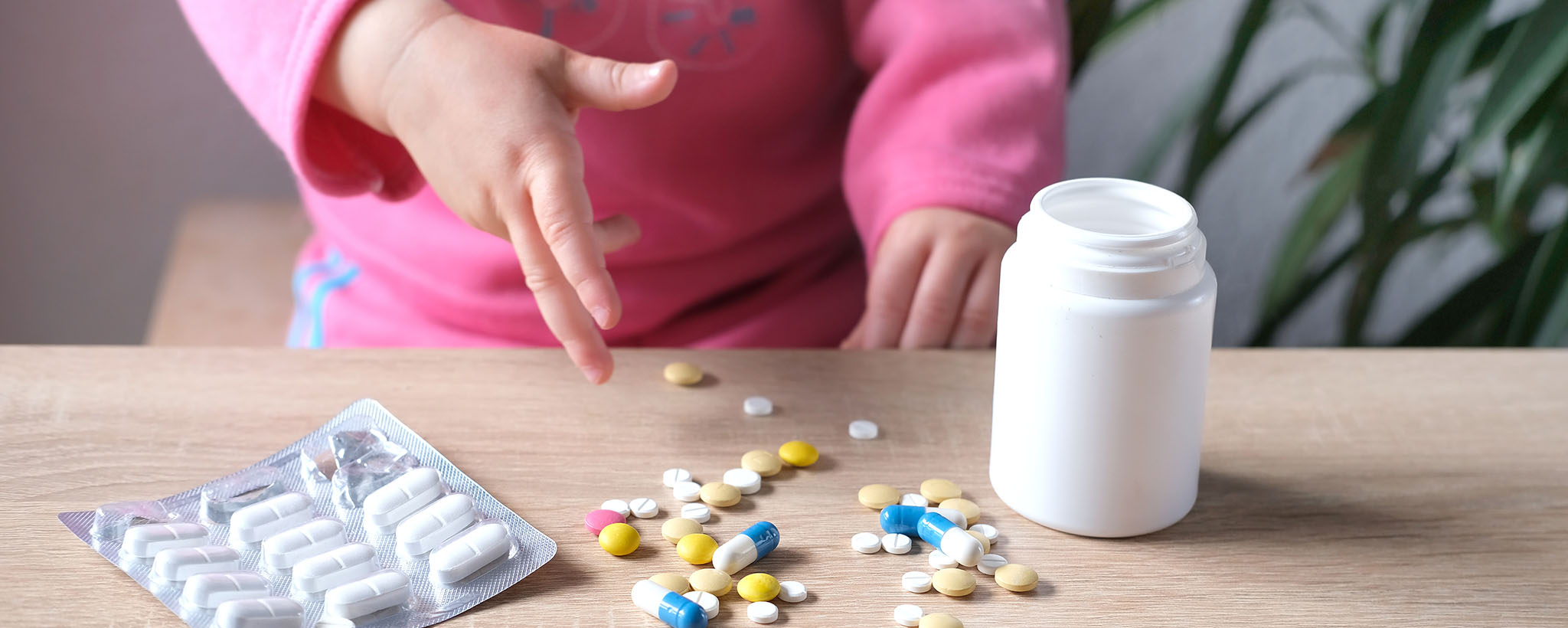 toddler playing with medication